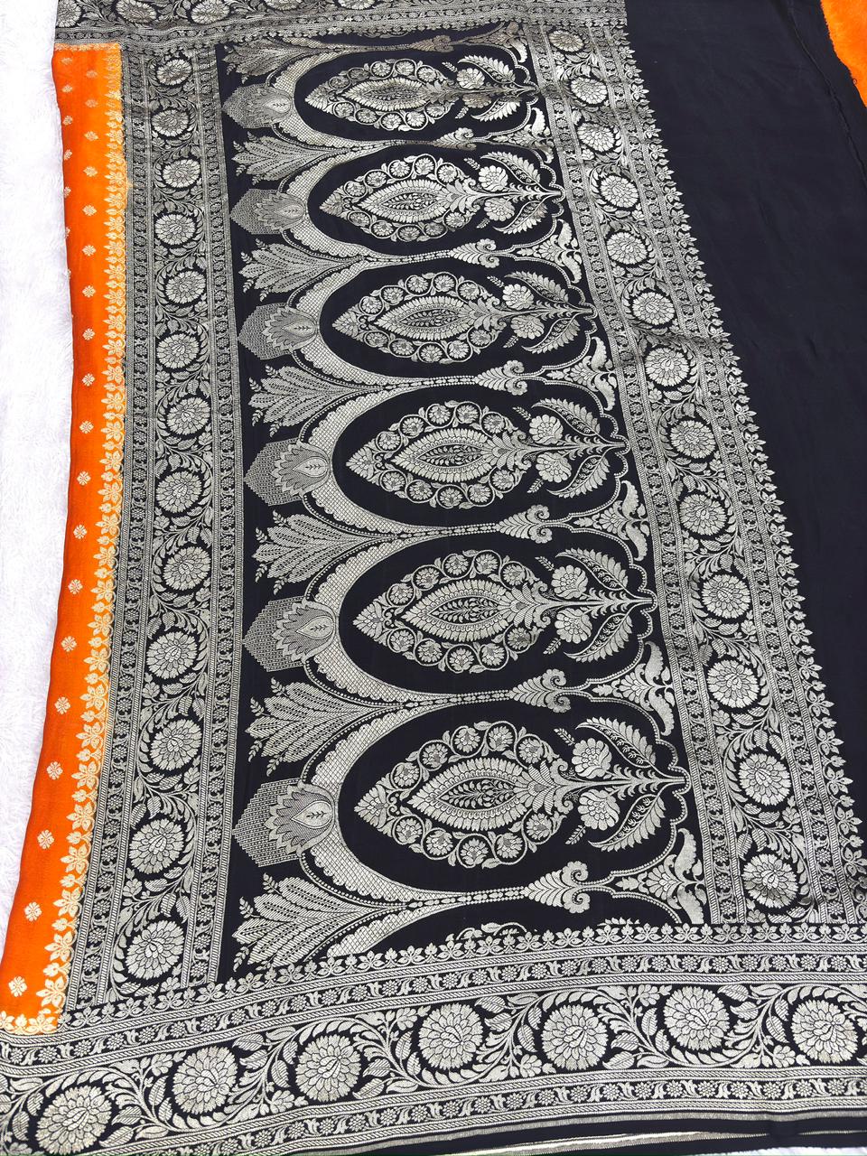 Vibrant Tangerine & Midnight Black Handloom Banarasi Crepe Georgette Saree with Silver Zari Buti & Scalloped Pallu
