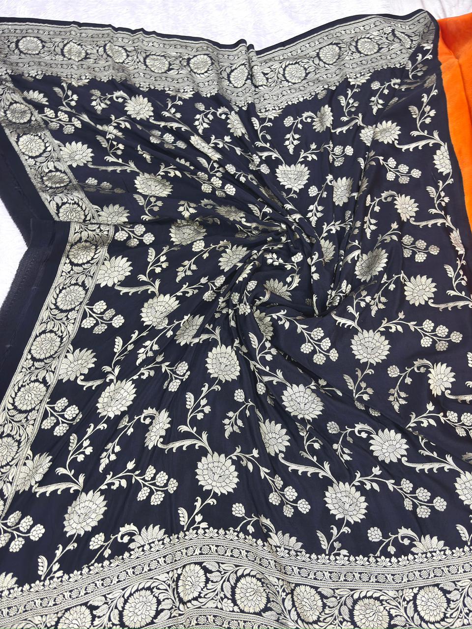 Vibrant Tangerine & Midnight Black Handloom Banarasi Crepe Georgette Saree with Silver Zari Buti & Scalloped Pallu